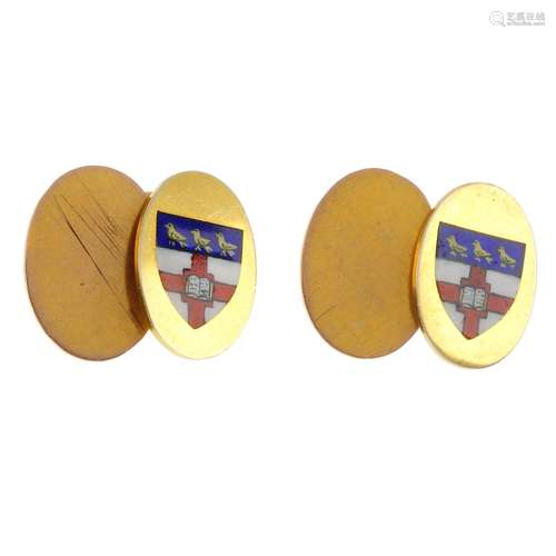 A pair of 1970s 9ct gold enamel cufflinks. Each designed as two oval-shape panels, one with vari-