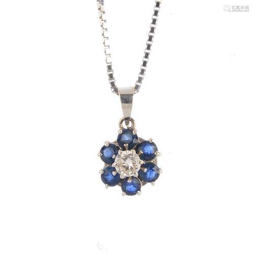 An 18ct gold sapphire and diamond pendant. The brilliant-cut diamond, with circular-shape sapphire