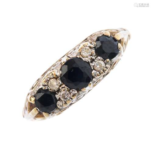 A 9ct gold diamond and sapphire dress ring. The graduated circular-shape sapphire line, with