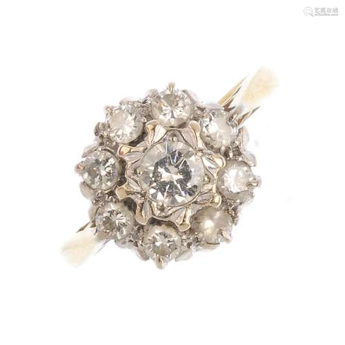 An 18ct gold diamond cluster ring. The central brilliant-cut diamond, with similarly-cut diamond