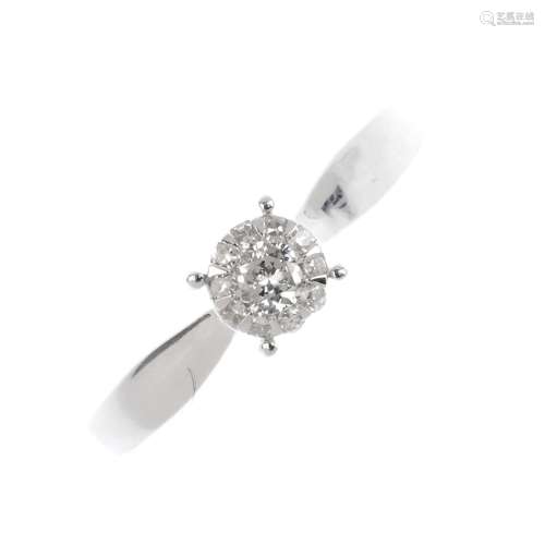 A 9ct gold diamond cluster ring. The brilliant-cut diamond, with single-cut diamond surround.