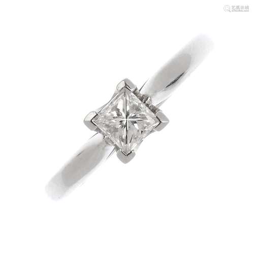 A platinum diamond single-stone ring. The square-cut diamond, with tapered shoulders. Diamond weight