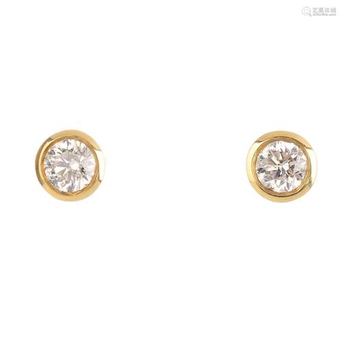 A pair of 18ct gold brilliant-cut diamond collet mounted stud-earrings. Total diamond weight 0.62ct,