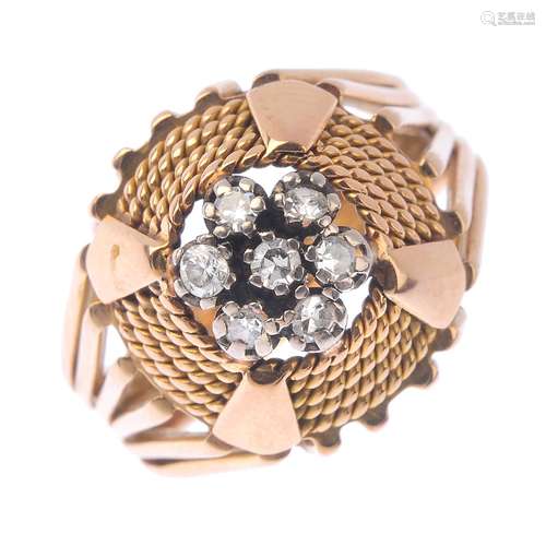 A diamond cluster ring. The single-cut diamond floral cluster, within a rope-twist border, to the