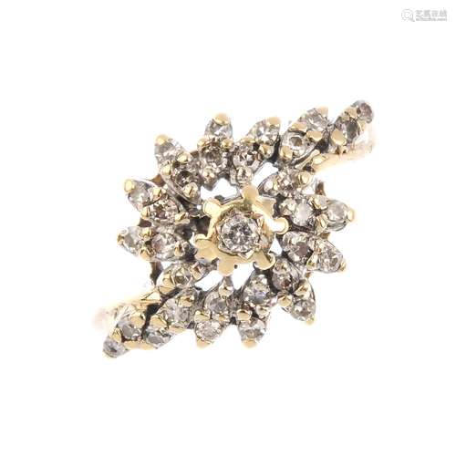 A 9ct gold diamond cluster ring. The brilliant-cut diamond, with single-cut diamond asymmetric