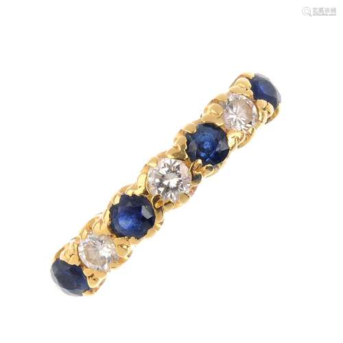 An 18ct gold sapphire and diamond seven stone ring. Designed as four circular-shape sapphires