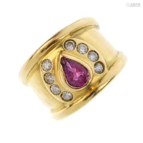 A ruby and diamond dress ring. The pear-shape ruby collet, with brilliant-cut diamond line sides,