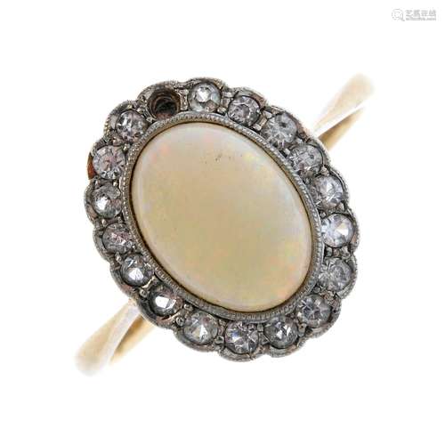 An opal and cubic zirconia cluster ring. The oval opal cabochon, with single-cut cubic zirconia