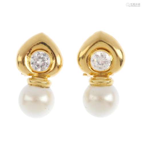 A pair of imitation pearl and cubic zirconia earrings. Each designed as an imitation pearl, with