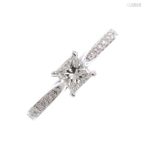 An 18ct gold diamond single-stone ring. The square-cut diamond, with brilliant-cut diamond