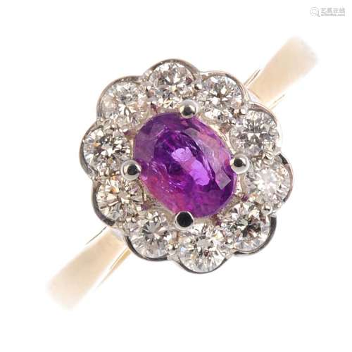 A sapphire and diamond cluster ring. The pink sapphire, weighing 0.80ct, with brilliant-cut