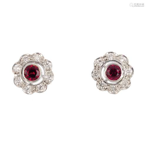 A pair of 18ct gold ruby and diamond cluster earrings. Each designed as a circular-shape ruby and