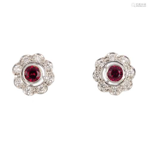 A pair of 18ct gold ruby and diamond cluster earrings. Each designed as a circular-shape ruby and