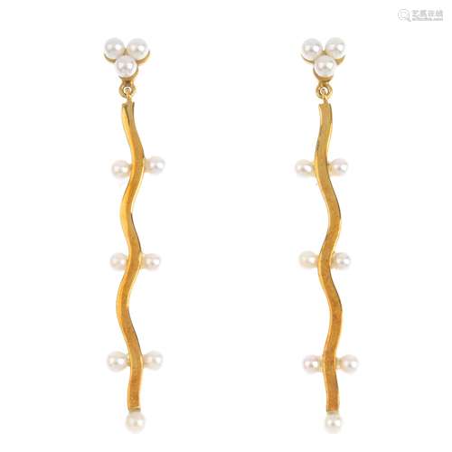 A pair of seed pearl earrings. Each designed as an undulating line with seed pearl highlights,