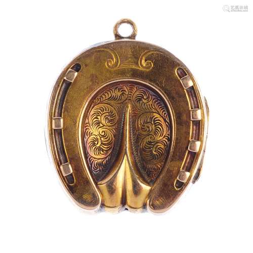 An early 20th century locket. The horseshoe locket, with engraved foliate motif and grooved