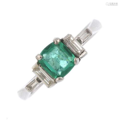 An emerald and diamond ring. The cushion-shape emerald, with baguette-cut diamond sides and