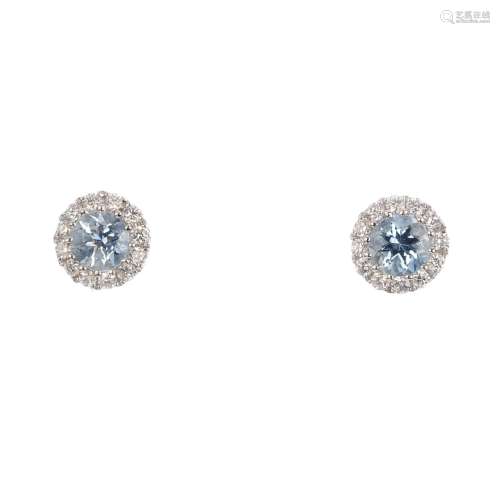 A pair of 18ct gold aquamarine and diamond stud earrings. Each designed as a circular-shape