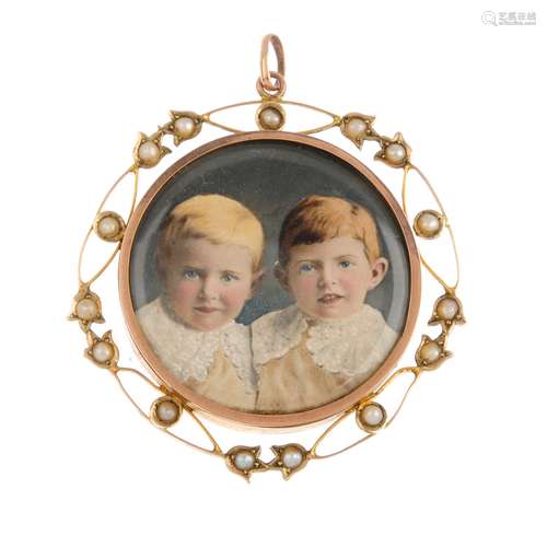 An early 20th century gold and split pearl miniature portrait pendant. Of circular outline, the