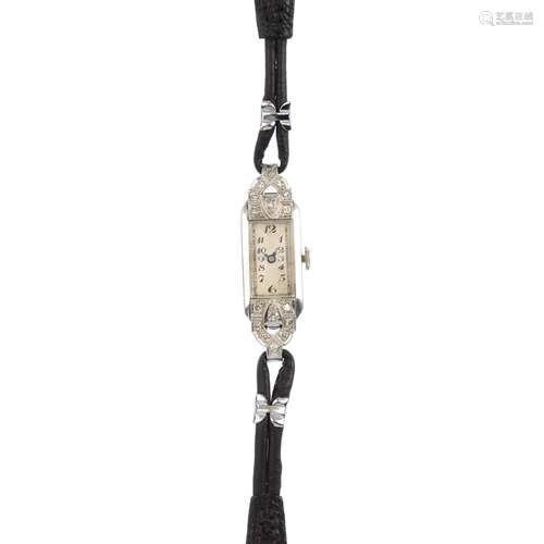 A lady's early 20th century platinum and diamond wrist watch. The rectangular dial with Arabic