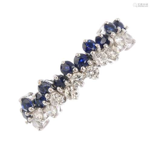 A sapphire and diamond dress ring. Designed as a series of brilliant-cut diamond and circular-