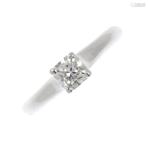 A platinum diamond single-stone ring. The square-cut diamond, with tapered shoulders. Diamond weight