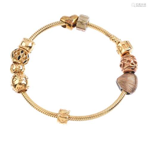 PANDORA and CLOGAU - a charm bracelet. The Pandora bracelet, suspending five Pandora and four Clogau