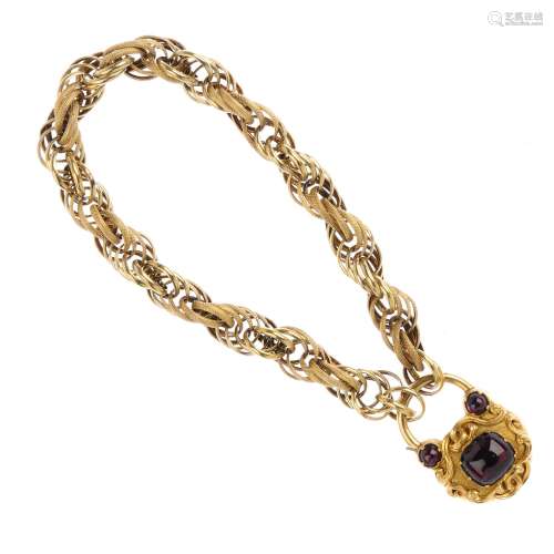 A late Victorian gold and gem-set bracelet. The fancy-link bracelet, with a cabochon garnet