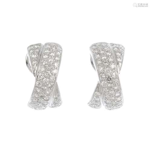 A pair of 18ct gold diamond earrings. Each designed as a pave-set diamond crossover half-hoop. Total