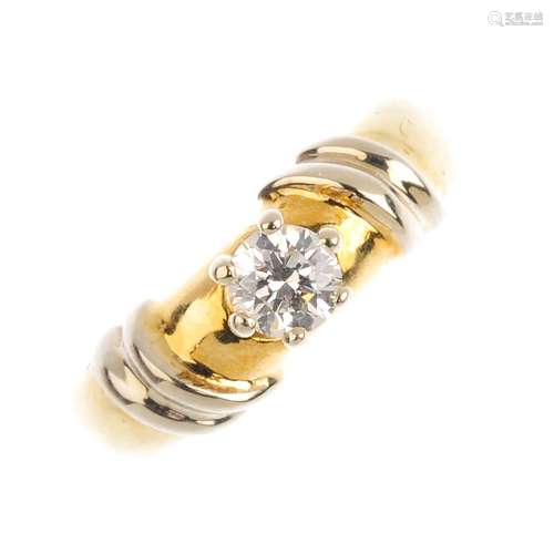 An 18ct gold diamond single-stone ring. The brilliant-cut diamond, with grooved shoulders. Estimated