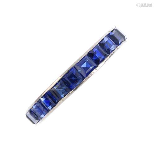 A sapphire eternity ring. The square-shape sapphire line, within a channel setting. Ring size M.