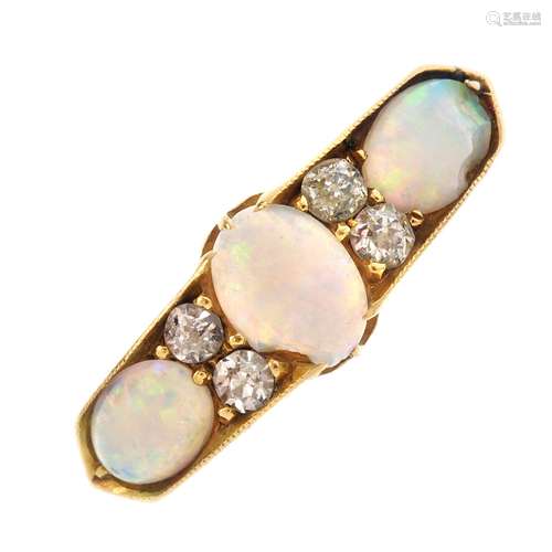 An Edwardian 18ct gold opal and diamond ring. The oval opal cabochon line, with circular-cut diamond