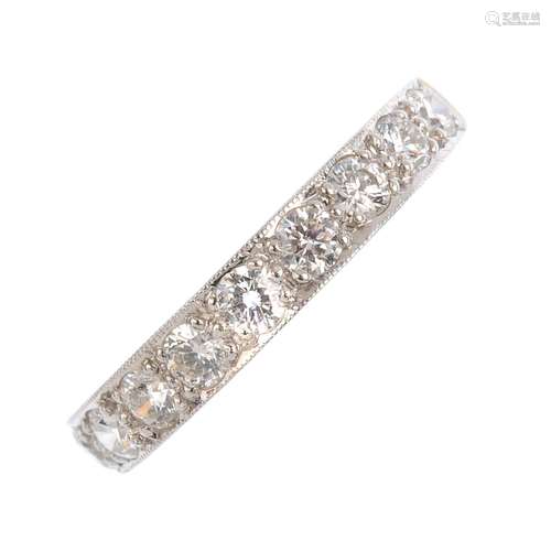 An 18ct gold diamond half eternity ring. Designed as a brilliant-cut diamond line. Total diamond