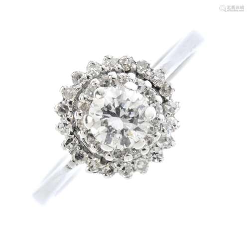 A diamond cluster ring. The brilliant-cut diamond, within a similarly-cut diamond double halo