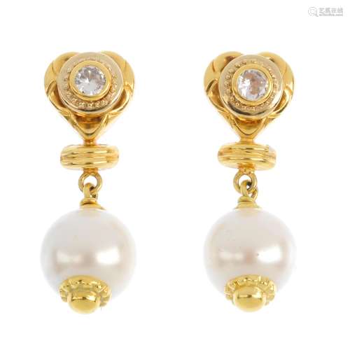 A pair of imitation pearl and cubic zirconia earrings. Each designed as an imitation pearl,