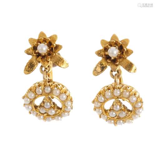 A pair of split pearl earrings. Each designed as a split pearl trefoil, within a split pearl halo,