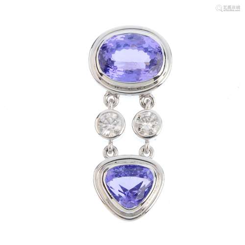 A tanzanite and diamond pendant. The oval-shape tanzanite collet, with brilliant-cut diamond