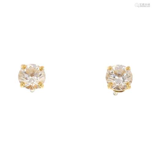 A pair of brilliant-cut diamond stud earrings.