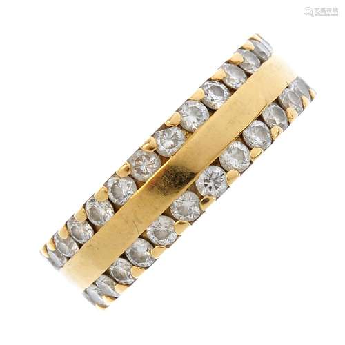 An 18ct gold diamond band ring. The polished band, with brilliant-cut diamond line sides.