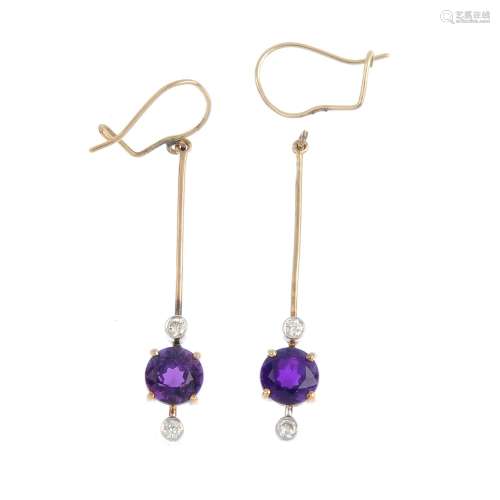 A pair of amethyst and diamond earrings. Each designed as a circular-shape amethyst, suspended