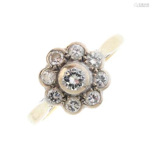 An 18ct gold diamond cluster ring. The brilliant-cut diamond collet, with similarly-cut diamond