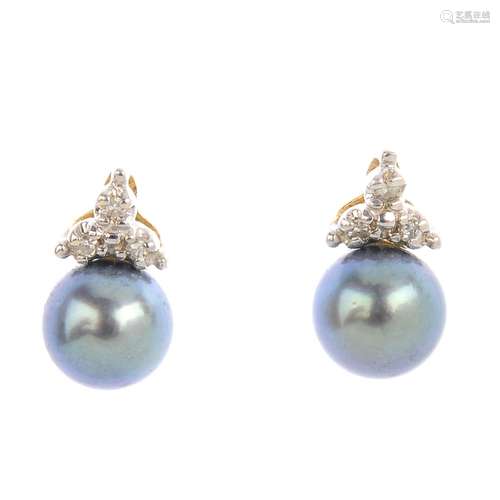 A pair of cultured pearl and diamond earrings. Each designed as a cultured pearl measuring 6.7mms