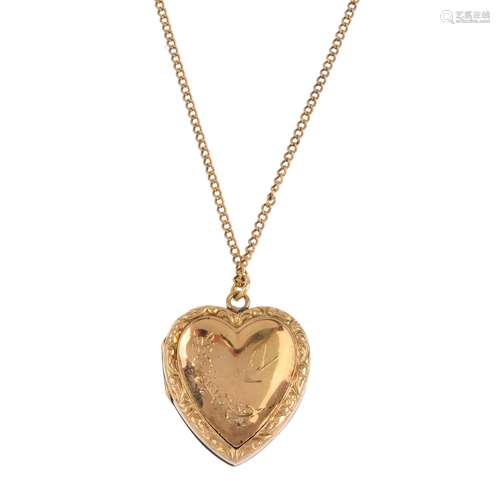 A mid 20th century 9ct gold back and front locket, with chain. The heart-shape locket, with engraved