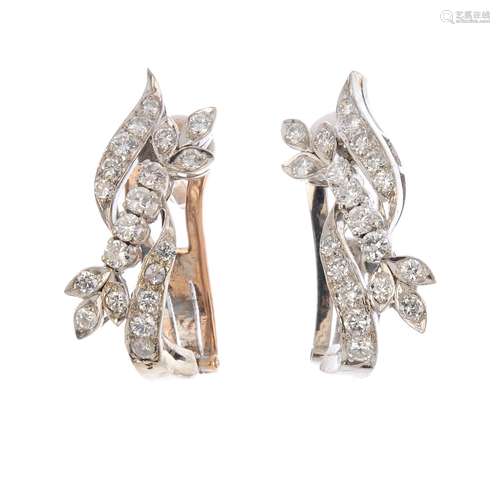 A pair of diamond earrings. Each designed as three brilliant-cut diamond off-set lines, one with