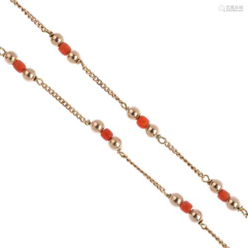A 9ct gold coral necklace. Designed as a series of polished sphere and coral beads, interspaced