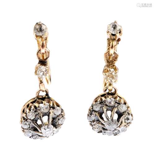 A pair of diamond earrings. Each designed as an old-cut diamond cluster drop, suspended from a