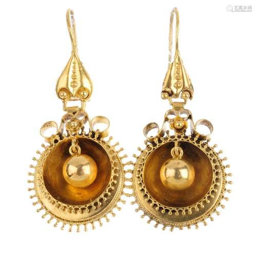 A pair of earrings. Each designed as a polished sphere, within a twisted rope and bead double