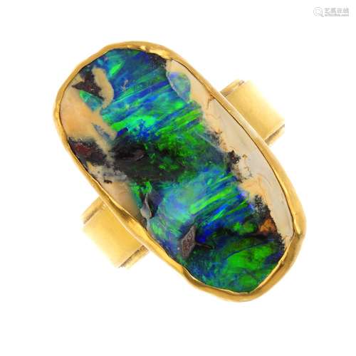 An opal dress ring. Designed as a boulder opal collet, with grooved band. Estimated dimensions of