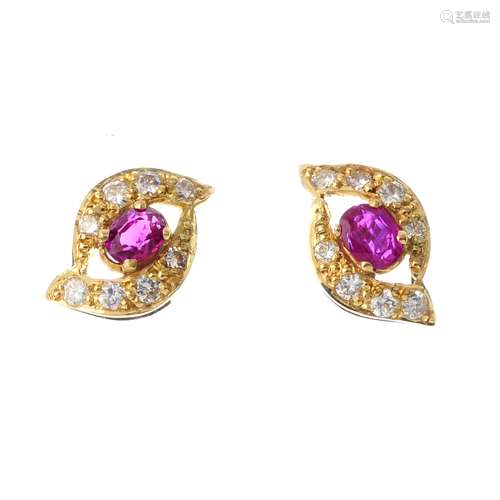 A pair of 18ct gold ruby and diamond ear studs. Each of tapered marquise shape with central oval-