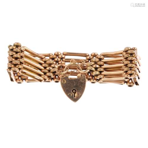 An early 20th century gold bracelet. Designed as a series of five-bar links, with textured brick-