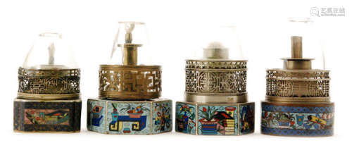 Four Chinese opium lamps each on cloisonne enamelled bases, each decorated with panels of lamps, plants and fauna, height 12cm (4)